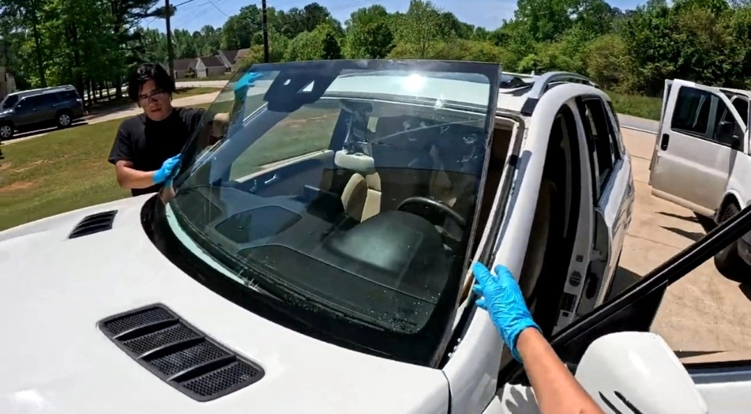 Mobile windshield replacement technician working at a customer home in Austin, TX
